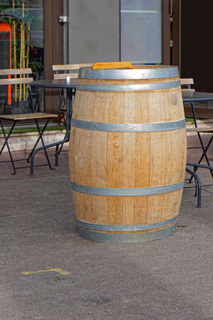 Big wooden wine barrel in front of bar