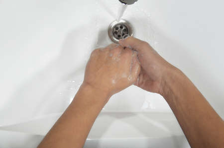 Washing hands under the water tap. Daily hygiene. Part of body. Image