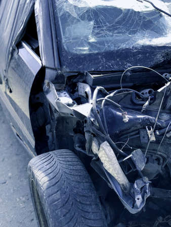 An old, broken car with a cracked windshield after an accident. Image