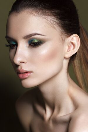 Beautiful young model with fashion make up, perfect skin. Trendy colorful smoky eyes. Green smoky eyesの写真素材