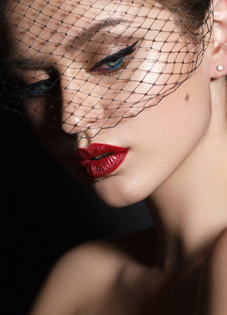 Close up portrait of beautiful young model with professional makeup, perfect skin. Trendy eyelines and red lips. Hollywood star styleの写真素材
