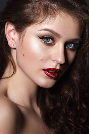 Close up portrait of beautiful young model with professional makeup, perfect skin. Trendy eyelines and red lips. Hollywood star styleの写真素材