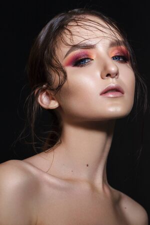 Portrait of beautiful young model with professional makeup, perfect skin, wet hairdo. Trendy colorful smoky eyes.の写真素材