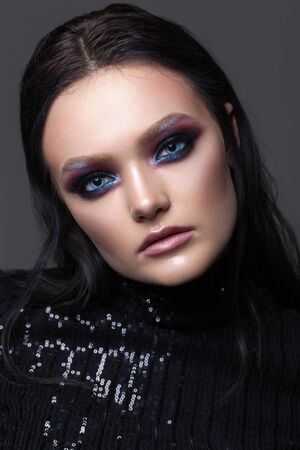 Attractive sexy girl with professional evening makeup, perfect shining skin, dark hair. Colorful smoky eyes.の写真素材