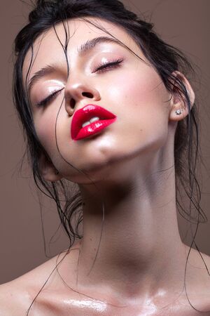 Young model with professional makeup, perfect skin, wet hairdo, closed eyesの写真素材