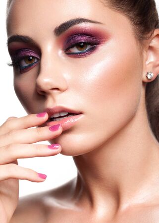 Attractive young beauty model with evening make up, perfect skin and nude lips. Trendy colorful smoky eyesの写真素材