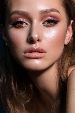 Close up portrait of beautiful young woman with professional makeup, perfect skin, colorful eyeshadows.の写真素材
