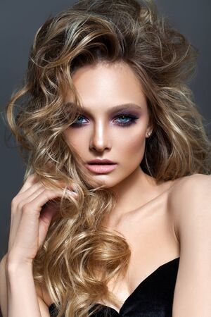 Beautiful young blond model with professional makeup, perfect skin, volume hairstyleの写真素材