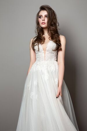 Bride photo of a beautiful model with bride makeup and hairstyle. Model dressed in white lace bride dress.の写真素材