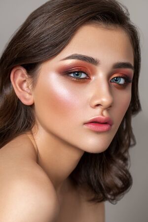 Beautiful young model with a very beautiful colorful smoky eyes, bright blue eyes and natural hairdoの写真素材
