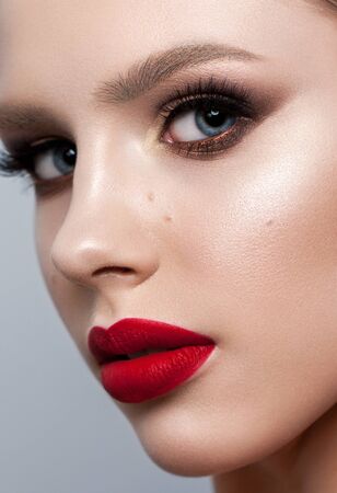 Close up portrait of a beautiful young model with bright evening make up, perfect skin.の写真素材