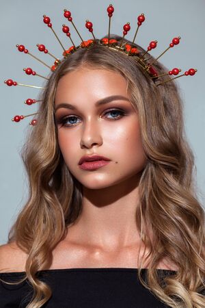 Fashion portrait of beautiful young model with professional makeup, perfect skin and Halo crown on her head.の写真素材