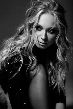 Beautiful sexy fashion model with evening professional makeup, wavy hair, perfect skin, black dress. Black and white photoの写真素材