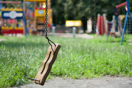 Broken swing in child areaの写真素材