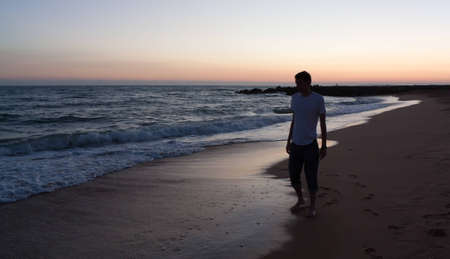 Man at walking along the seaの写真素材