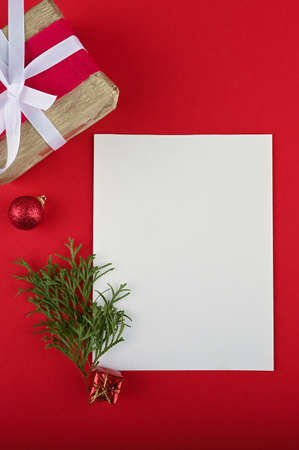 New year wish list with festive elements on red table.の写真素材