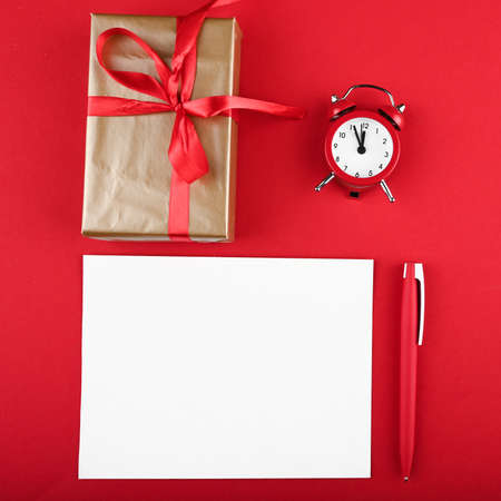 Christmas flat lay with gift box decor and blank card on red background. Time to shopping.
