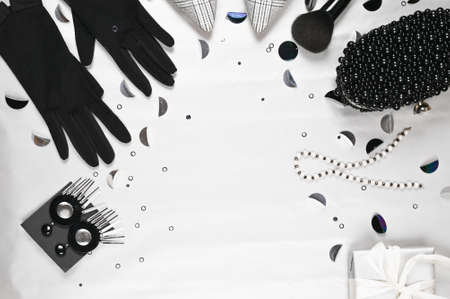 Festive fashion set of woman accessories: shoes, black bag and gloves, makeup brush and gift box.の写真素材