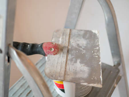 Construction trowel, paint bucket and ladder. renovation concept