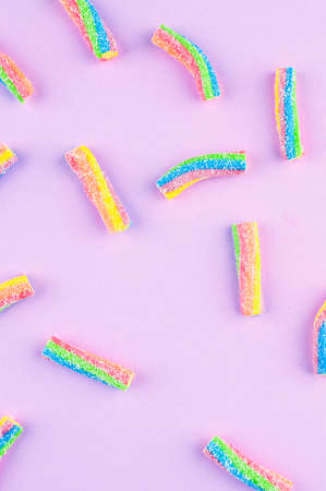 Rainbow jelly candies on a colored background.の写真素材