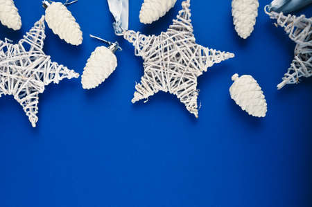 Christmas holiday frame with festive decorations on blue surface.の写真素材