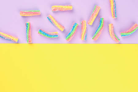 Rainbow jelly candies on a paper backdrop.の写真素材