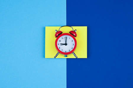 Red alarm clock on multi-colored background.の写真素材