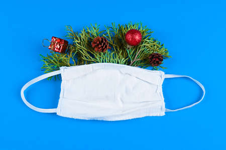 Protective medical mask with christmas decorations. Winter, New Year greeting card. Second wave conceptの写真素材