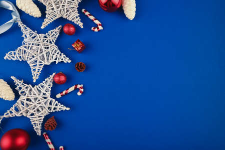 Christmas holiday frame with festive decorations on blue surface.の写真素材