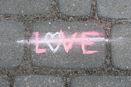 Love crossed out, chalk lettering on gray background.の写真素材