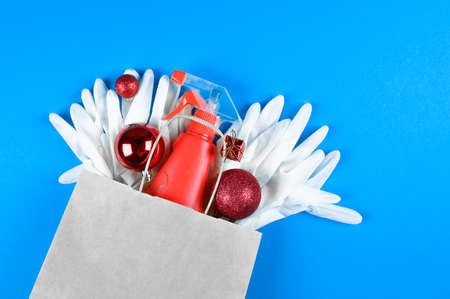 Christmas balls, disinfectants and anti-virus products in a paper bag. Xmas shopping during pandemic concept.の写真素材
