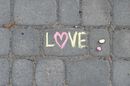 Lettering LOVE made iwith chalk on the road.の写真素材