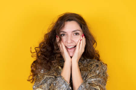 Closeup portrait of surprised beautiful caucasian woman holds cheeks by hand. Young attractive young...