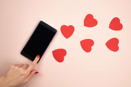 Smartphone love connection. Female hands holding celphone with blank display of phone for mockup....