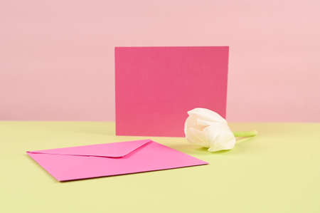 Blank card with pink paper envelope template mock up. Festive flat lay minimalist style. High...