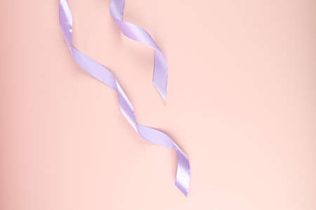 Top view of two glossy ribbons on pink background. High quality photoの写真素材