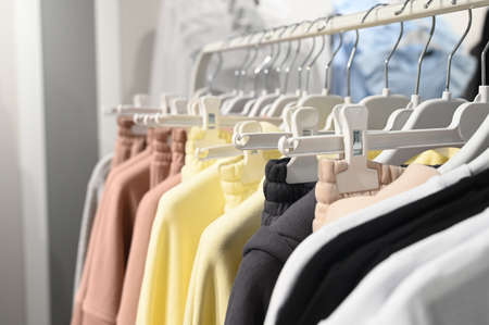 Fashionable bright women's clothing on a hanger in the store. Wardrobe Change Concept. High quality photoの写真素材