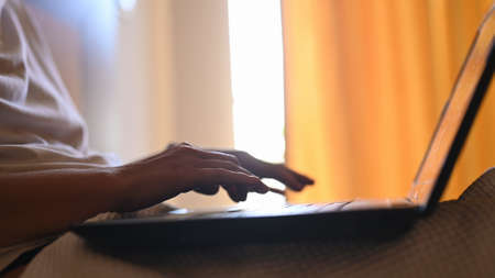 Young woman is working on a laptop, close up. Freelancer, remote work, work from home concept. High...