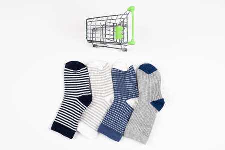 Tp view of shopping cart and multi colored socks. Consumer shopping concept. High quality photoの写真素材