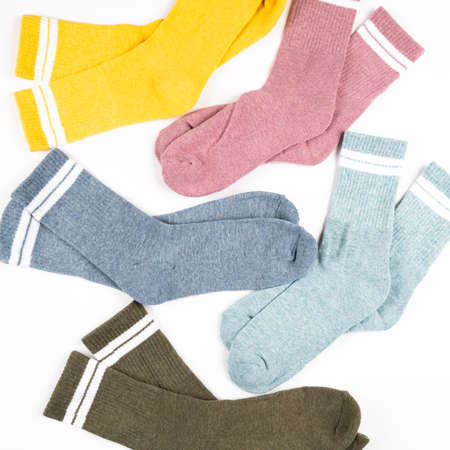 Warm multi colored women's socks with stripes isolated on white, top view. High quality photo