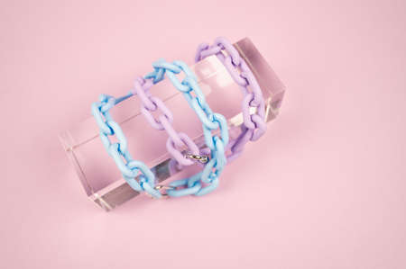 Blue and violet plastic choker on pink background. Stylish women's jewelry. Fashion concept. High quality photoの写真素材