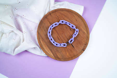 Stylish color necklace on round wooden stand. Stylish women's jewelry. Fashion concept. High quality photoの写真素材
