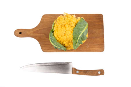 Top view of kitchen knife, fresh cauliflower on cutting board. High quality photoの写真素材