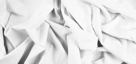 Crumpled white fabric, fabric background with folds. Top view. High quality photo