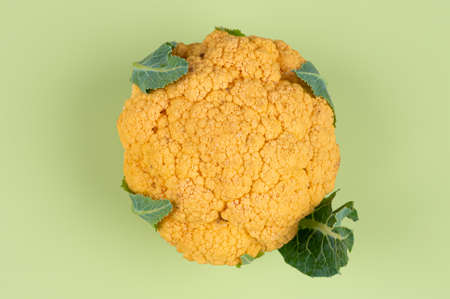 Top view of cauliflower cabbage with leaves on pastel green background. Healthy foodconcept. High quality photoの写真素材