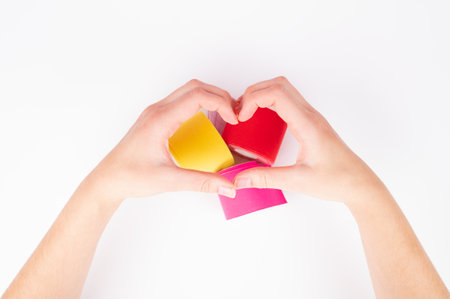Female hands making sign Heart by fingers. Sticks tape patch for face taping isolated on white.の写真素材