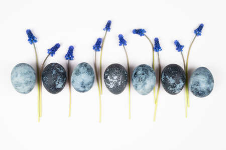 Easter frame of eggs painted in blue color with hyacinth flowers. Easter greeting card. Space galactic Easter eggsの写真素材