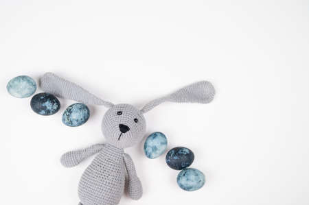 Top view of toy rabbit hunter with blue Easter eggs isolated on white. Happy Easterの写真素材