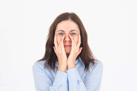 Woman doing face building self massage and rejuvenating exercises. Non-surgical rejuvenation and self-care concept.の写真素材