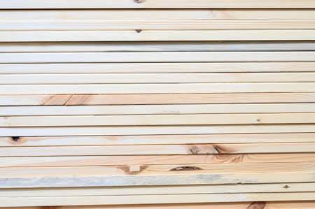 Wooden planks in store close-up. Wooden details of furniture. Wooden boards in a warehouse....